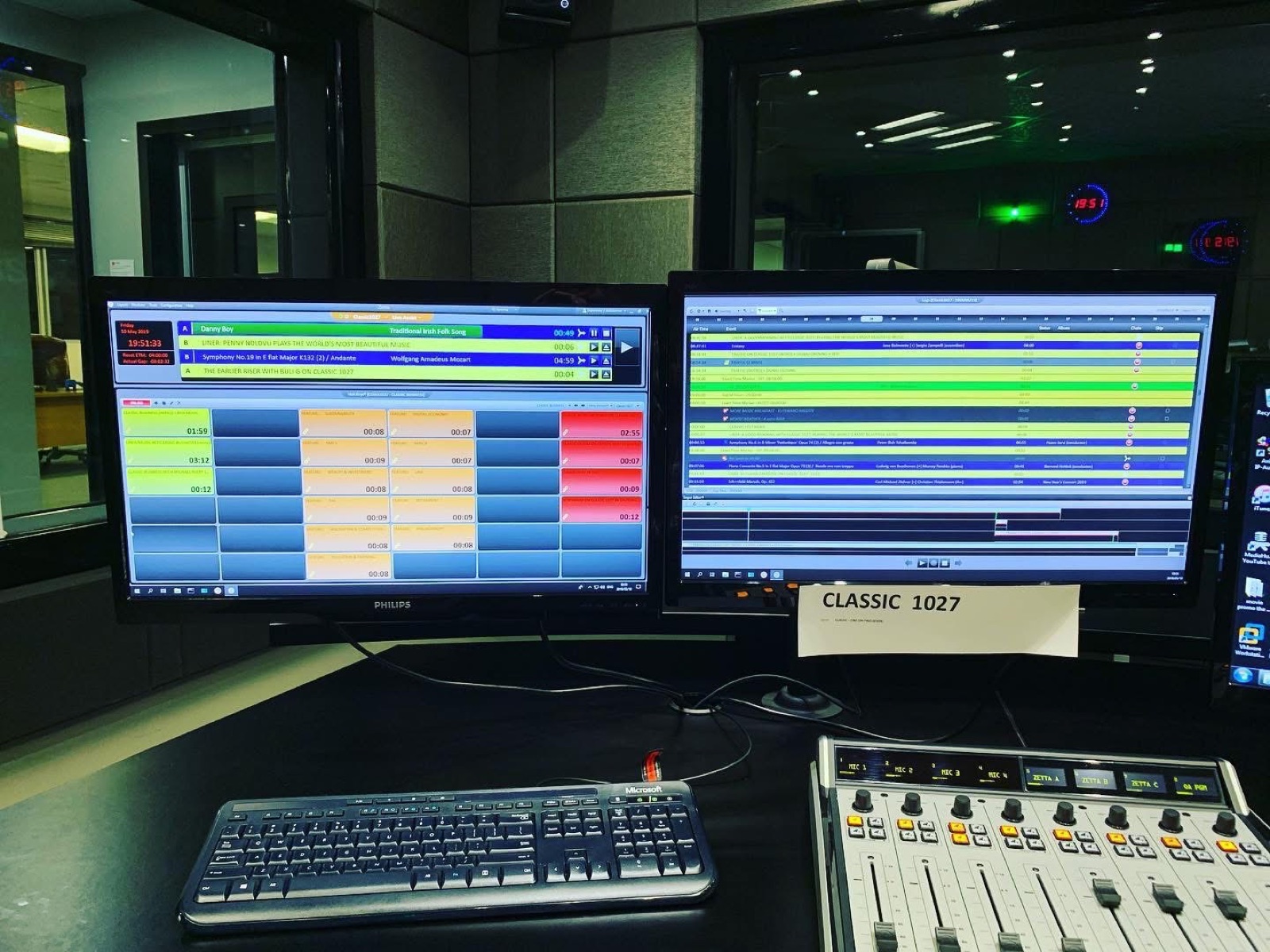 Audio console and playout screens in a radio control room